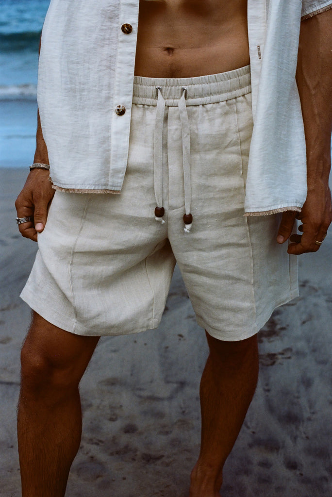 Close-up of man wearing our sand linen Easy Going Shorts with our featherweight Resort Shirt on top. 