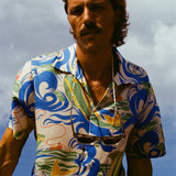 The same male model with longer hair and a mustache is staring into the camera, wearing our patterned 'Perfect Cast' Shirt and a pair of sunglasses are strapped around his neck. 