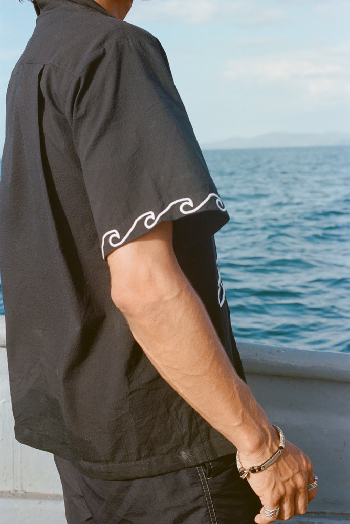 Image from the side of the white embroidered waves on the sleeve of the 'Unleashed' Shirt.
