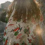 Person wearing a colorful shirt, walking away from the camera. 