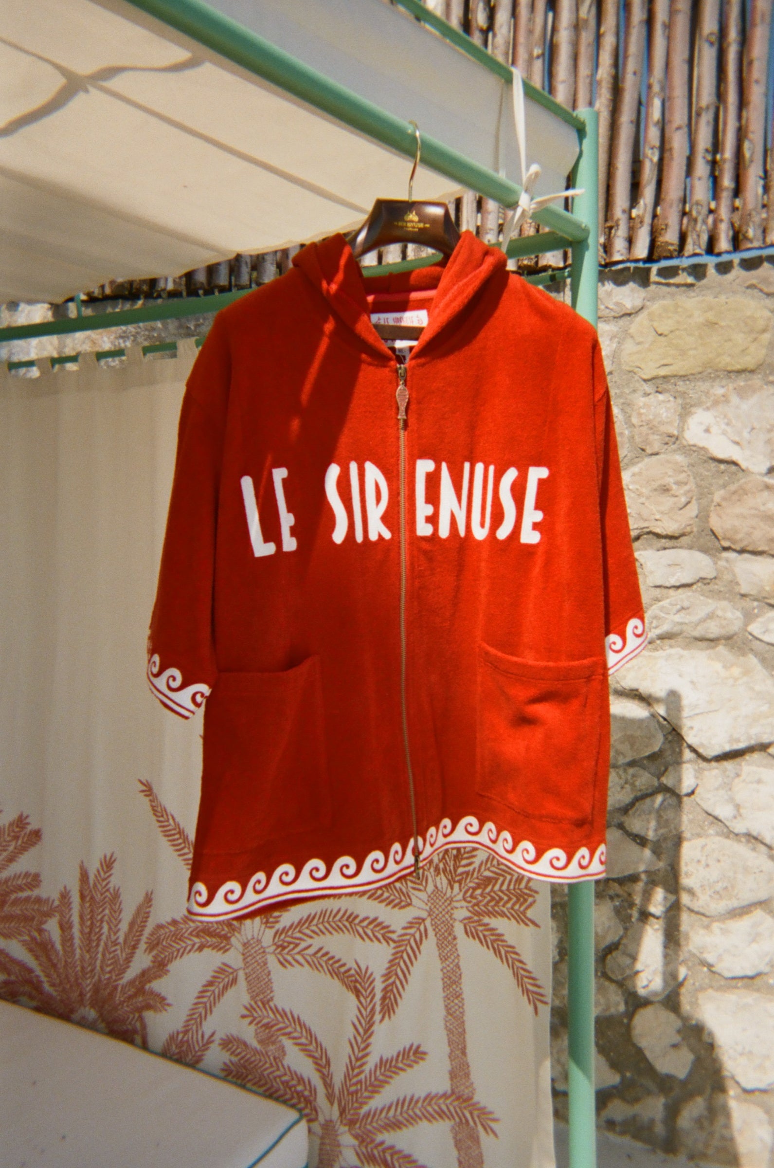 Le Sirenuse Beach Towel Top hanging outside by the pool. 