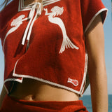 Red towel top with mirrored mermaid design.