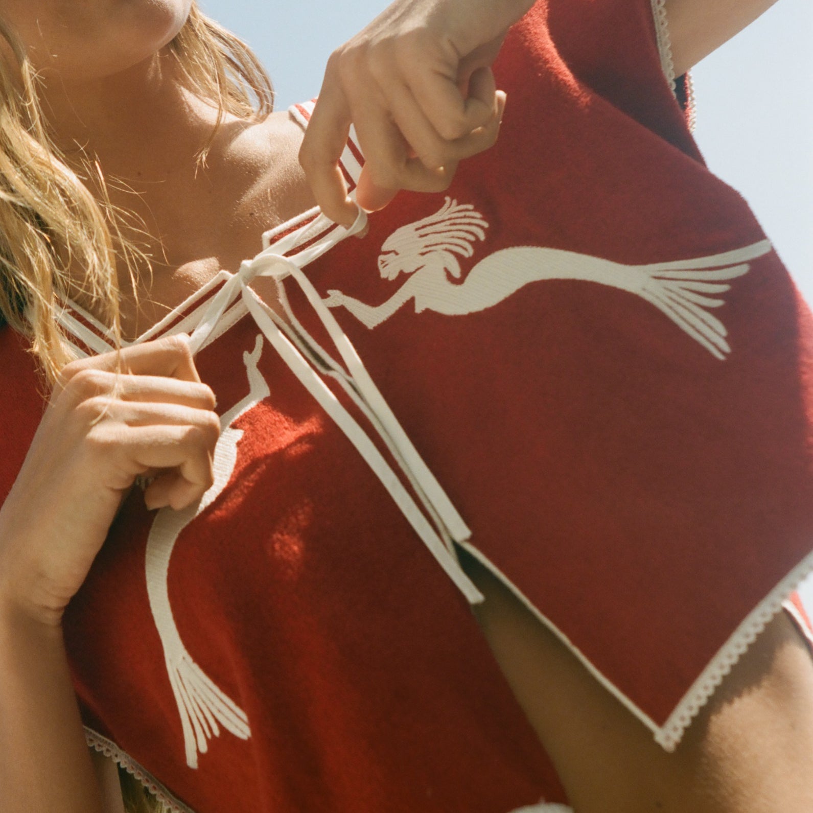 Red towel top with mirrored mermaid design.