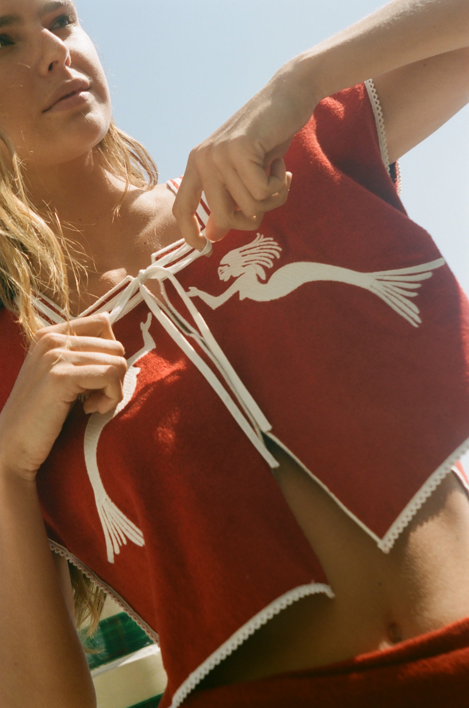 Red towel top with mirrored mermaid design.