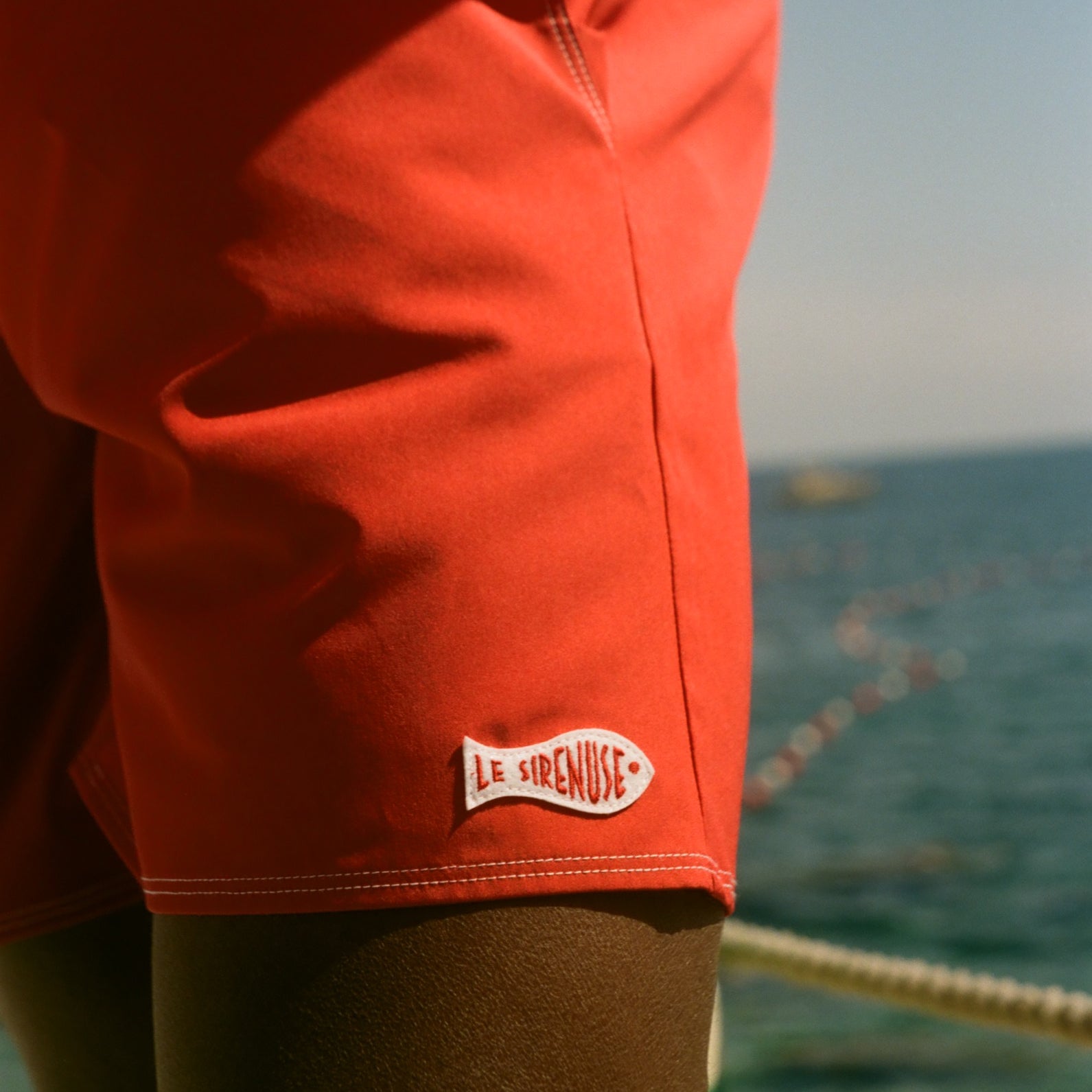 Close-up of a red trunks with Le Sirenuse logo.