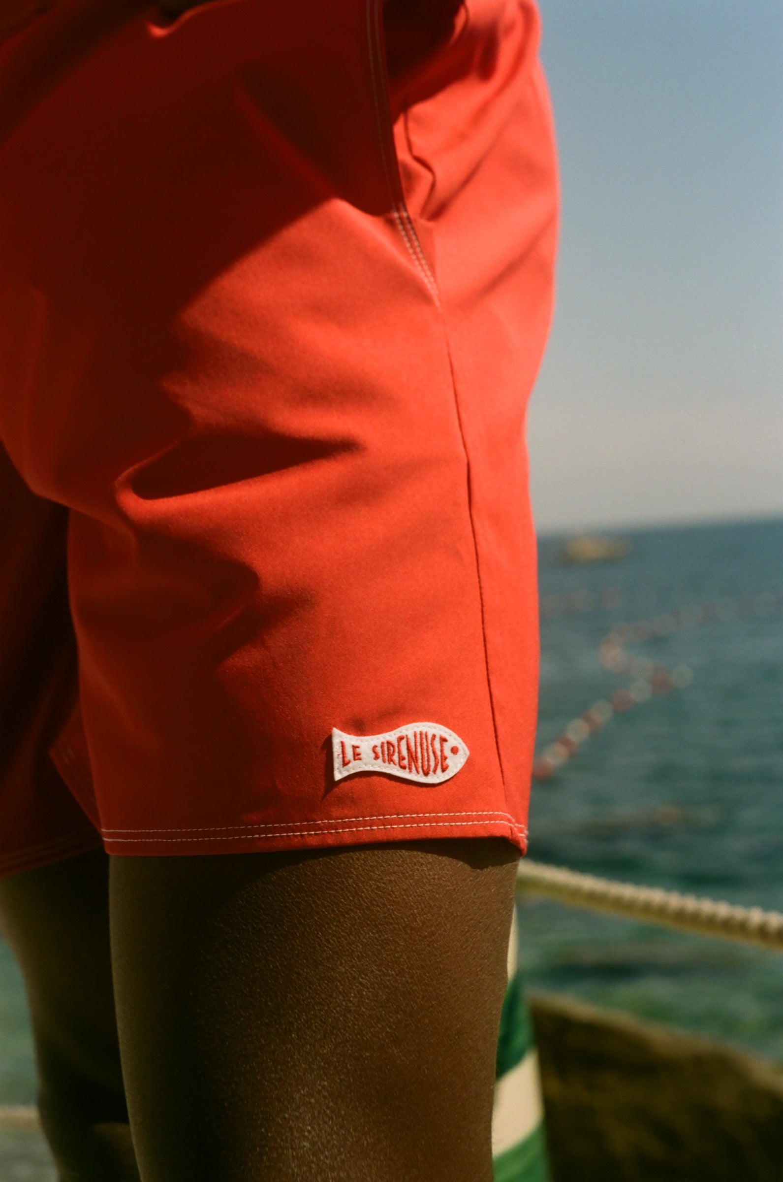 Close-up of a red trunks with Le Sirenuse logo.