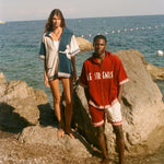 Two people standing on the beach, wearing the Le Sirenuse Checkout Cabana sets. 