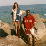 Two people standing on the beach, wearing the Le Sirenuse Checkout Cabana sets. 