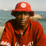 Man wearing red terry cloth Le Sirenuse bucket hat.