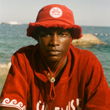 Man wearing red terry cloth Le Sirenuse bucket hat.
