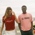 Two people wearing Le Sirenuse terry cloth t-shirts. 