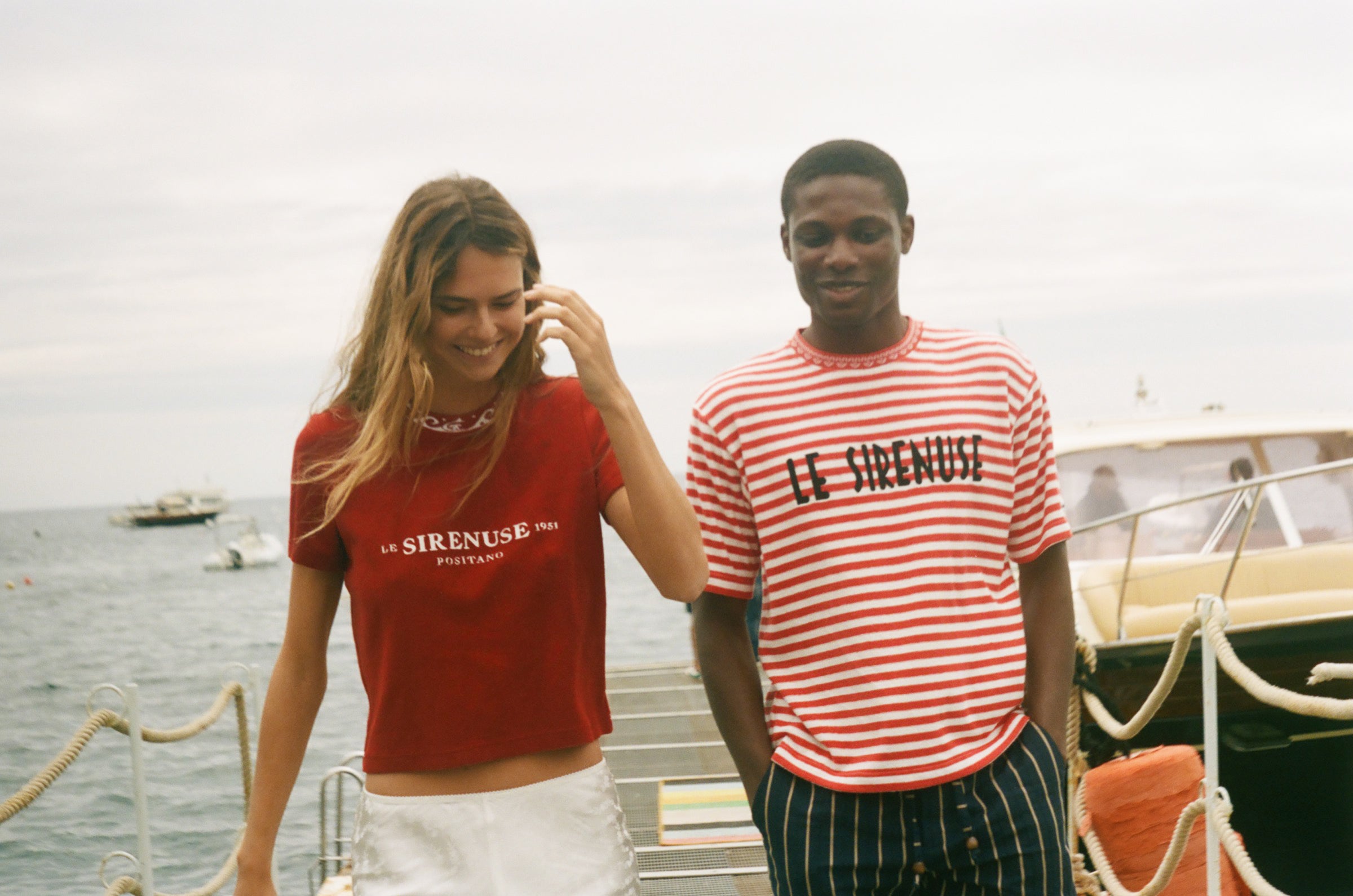 Two people wearing Le Sirenuse terry cloth t-shirts. 