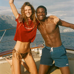 Two people on a boat with a scenic background