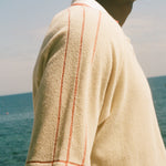 Close-up of red piping detailing on the Le Sirenuse polo shirt.