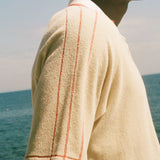 Close-up of red piping detailing on the Le Sirenuse polo shirt.