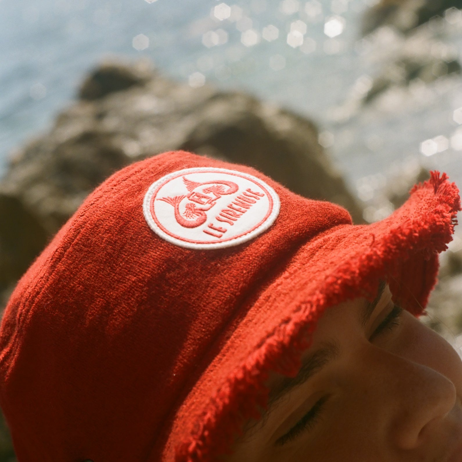 Close-up of the Le Sirenuse bucket hat patch.