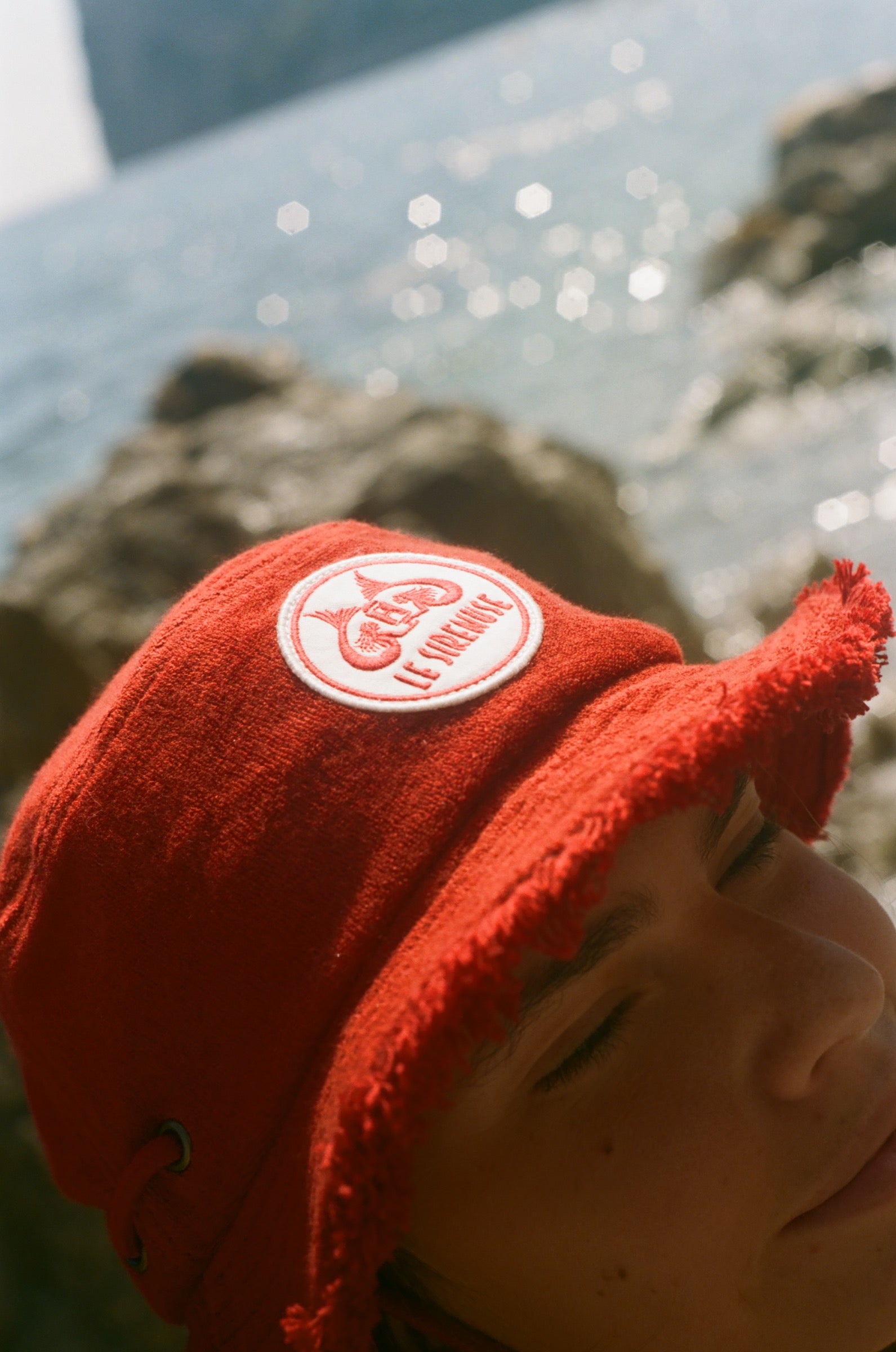 Close-up of the Le Sirenuse bucket hat patch.