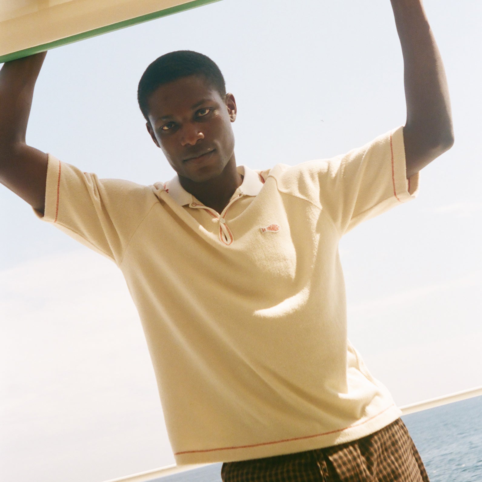 Man wearing beige Le Sirenuse polo.