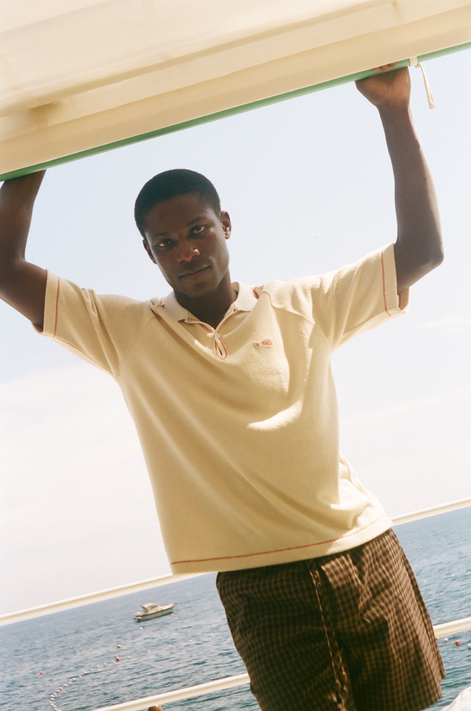 Man wearing beige Le Sirenuse polo.