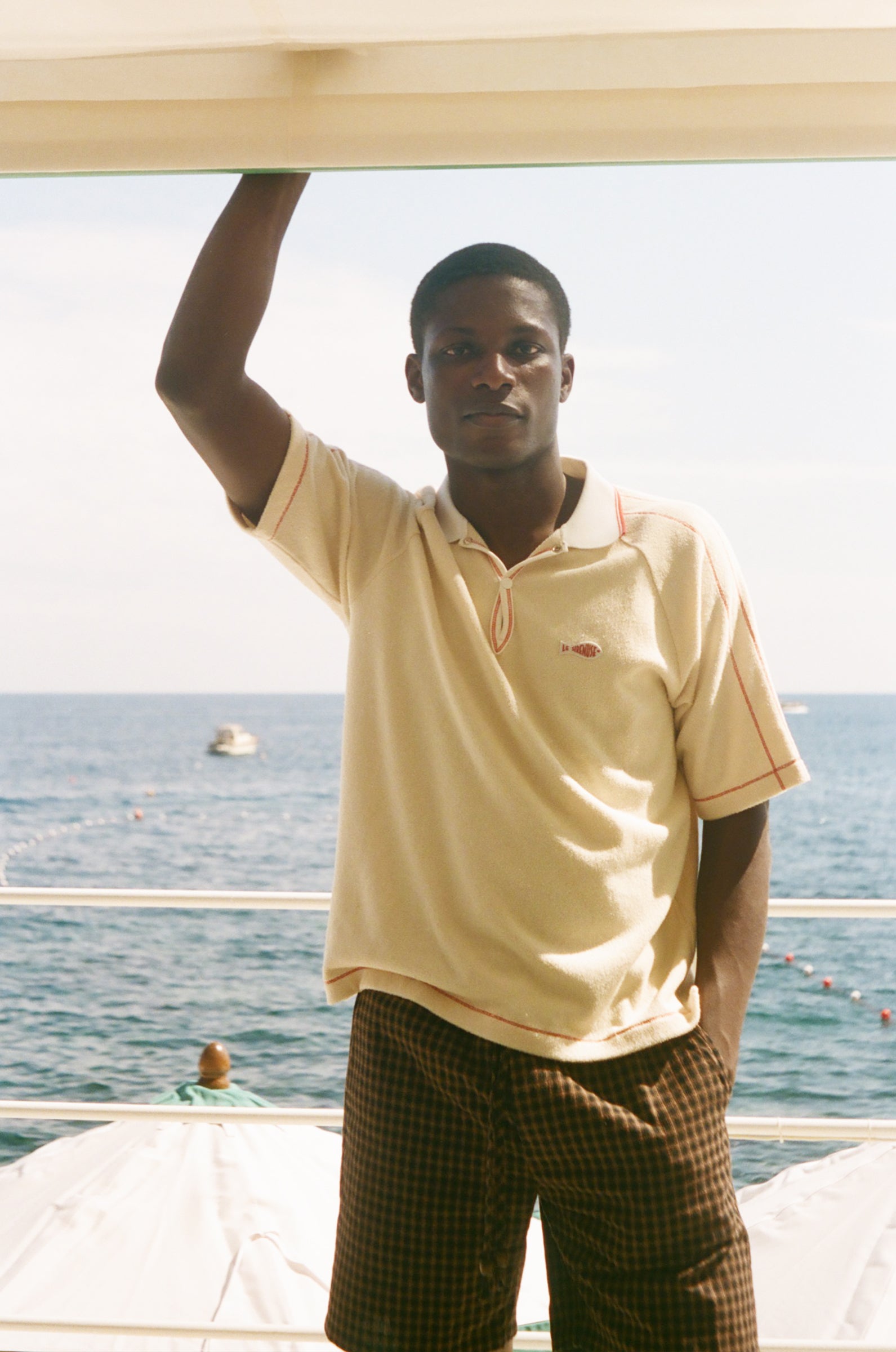 Man wearing beige Le Sirenuse polo.