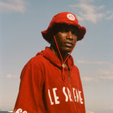Man wearing Le Sirenuse Cabana and matching bucket hat at the beach.