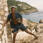 Man standing on rocks wearing Don't Worry matching set.