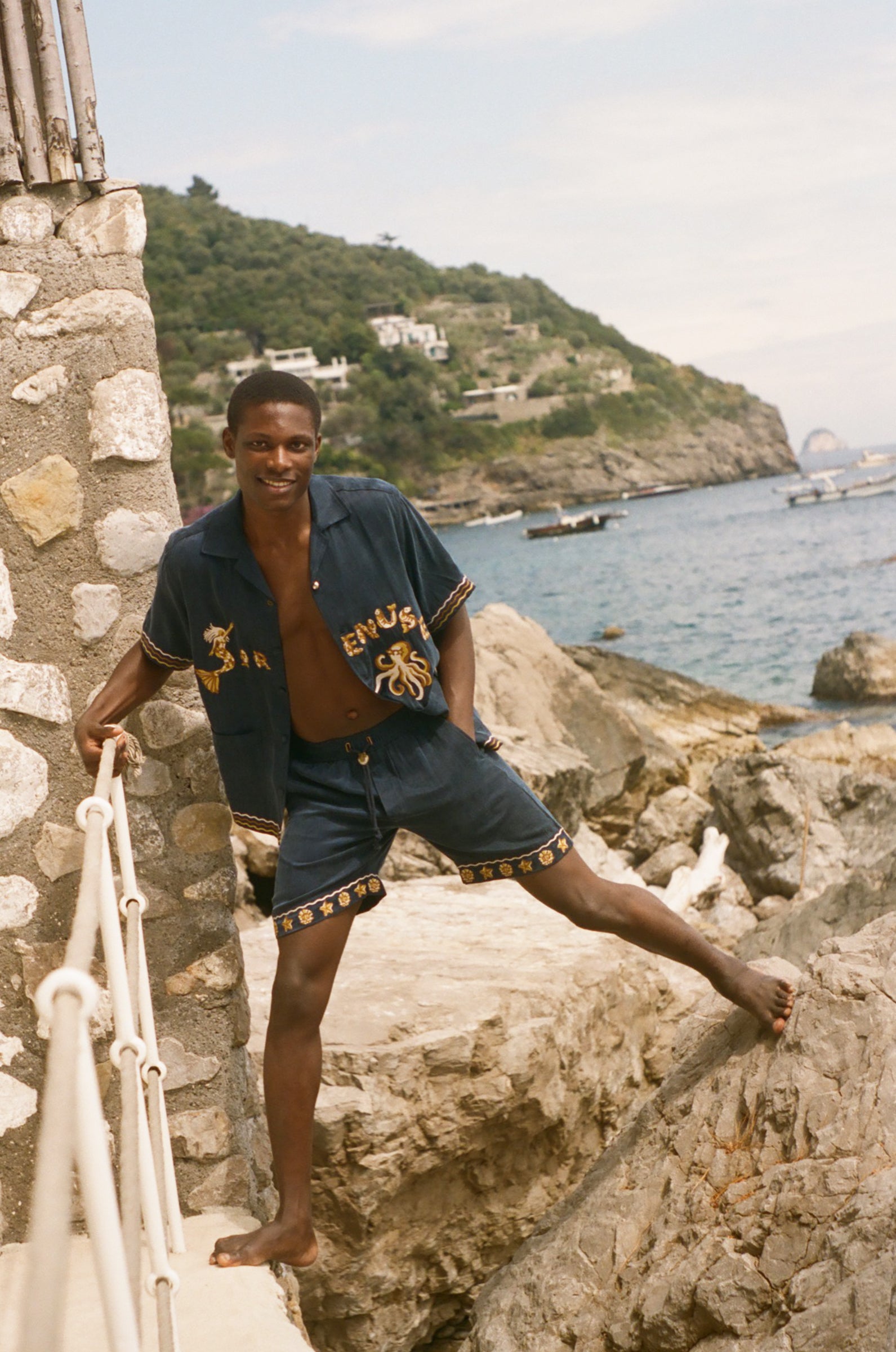 Man standing on rocks wearing Don't Worry matching set.