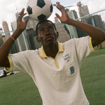 Person balancing a soccer ball on their head with a city skyline in the background, wearing the 'Where were you?' Cabana.
