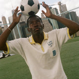 Person balancing a soccer ball on their head with a city skyline in the background, wearing the 'Where were you?' Cabana.