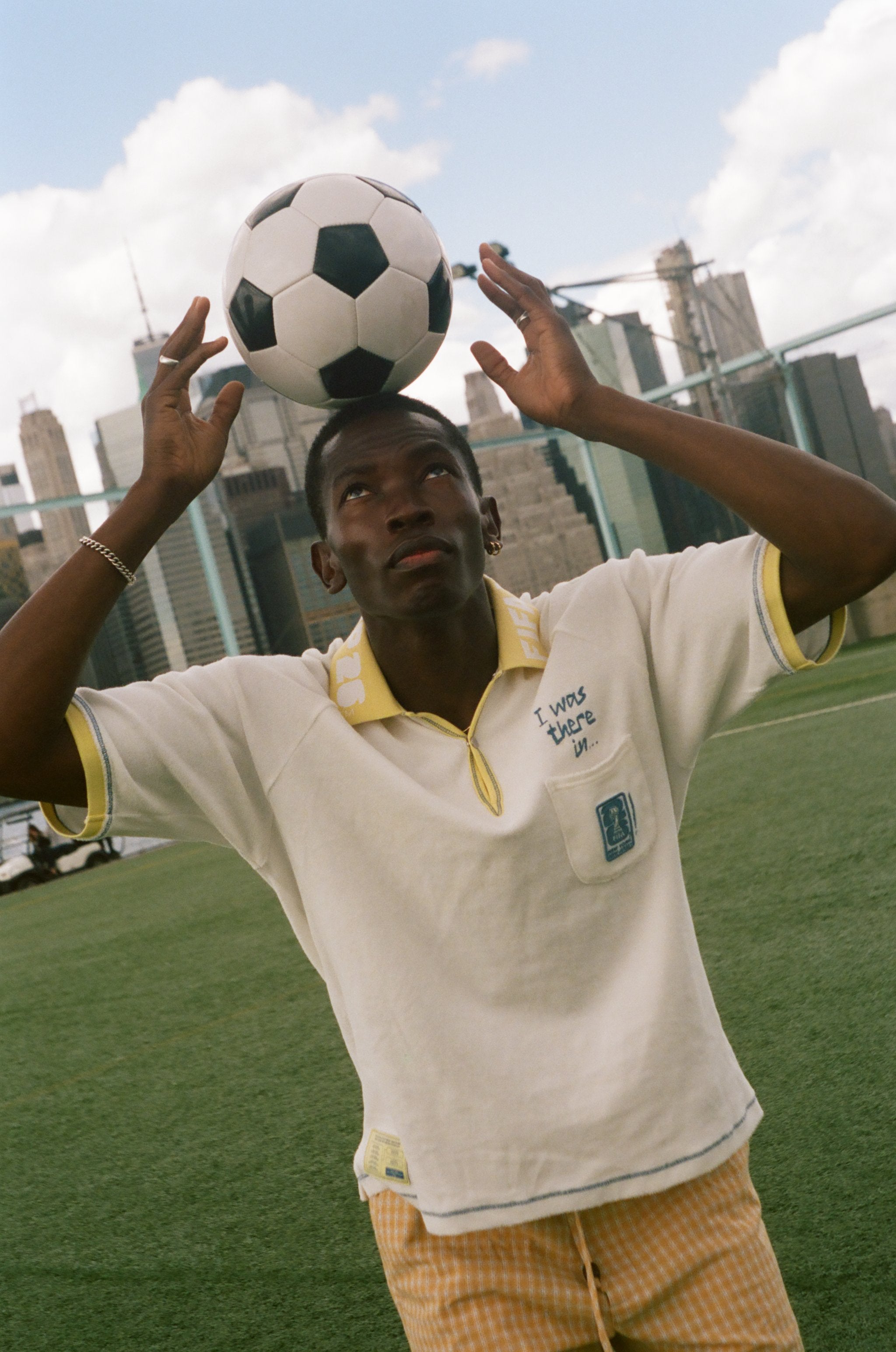 Person balancing a soccer ball on their head with a city skyline in the background, wearing the 'Where were you?' Cabana.