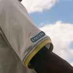 Man showing off the Tombolo patch on his right sleeve.