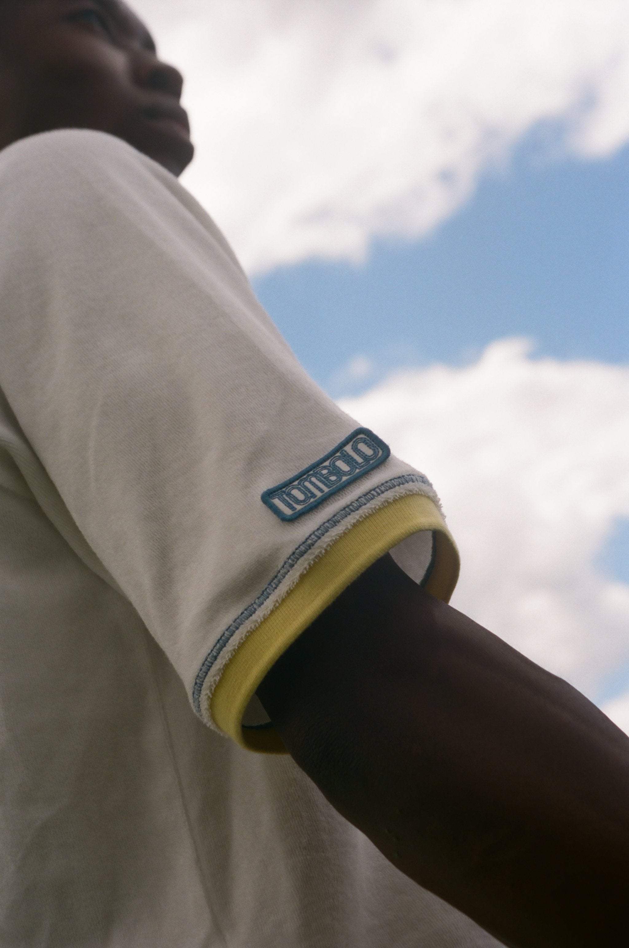Man showing off the Tombolo patch on his right sleeve.