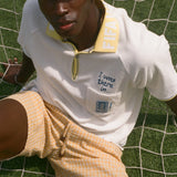 Man wearing FIFA Polo shirt, with 'I was there in..." chain-stitch embroidery over the chest pocket. He is also wearing a matching bucket hat.