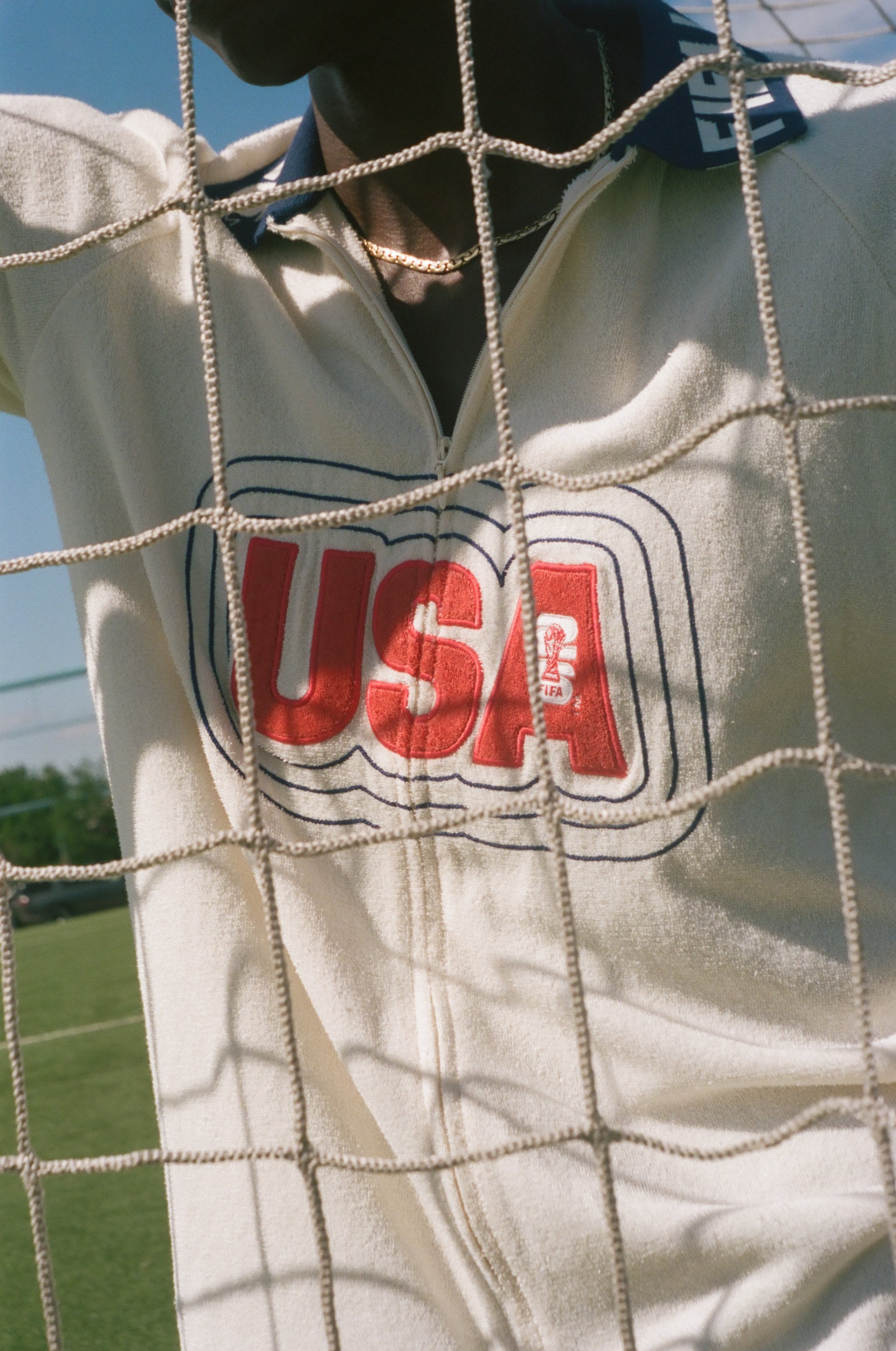 Close-up of a white cabana with 'USA' printed on it, through a net.