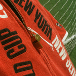 Close-up of the zipper pull: an antique-looking whistle.