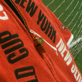 Close-up of the zipper pull: an antique-looking whistle.