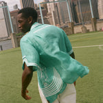 Man showing off the backside of the teal Stars and Stripes Cabana.