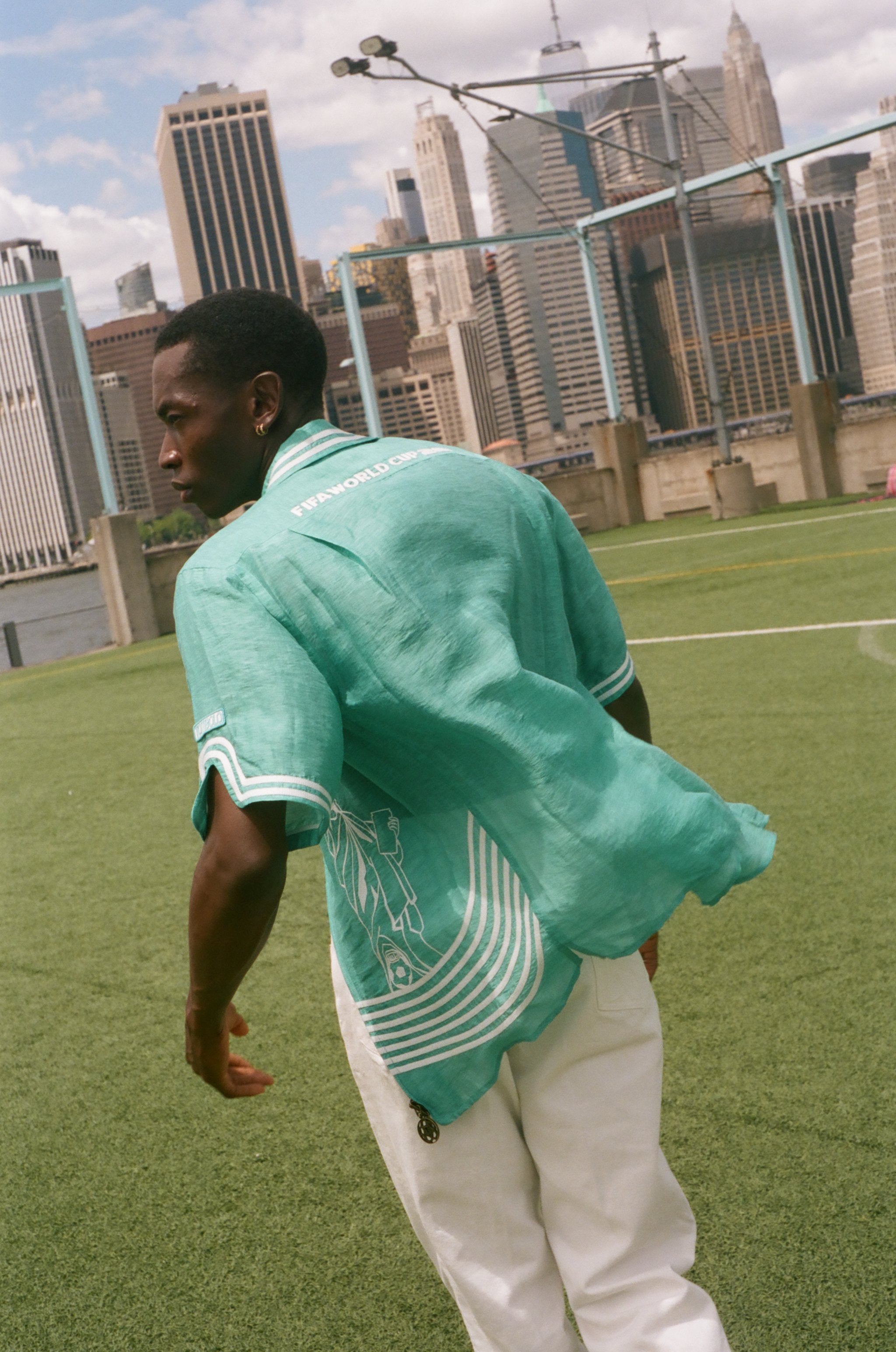 Man showing off the backside of the teal Stars and Stripes Cabana.