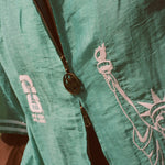Close-up of the soccer zipper pull on the teal cabana. 