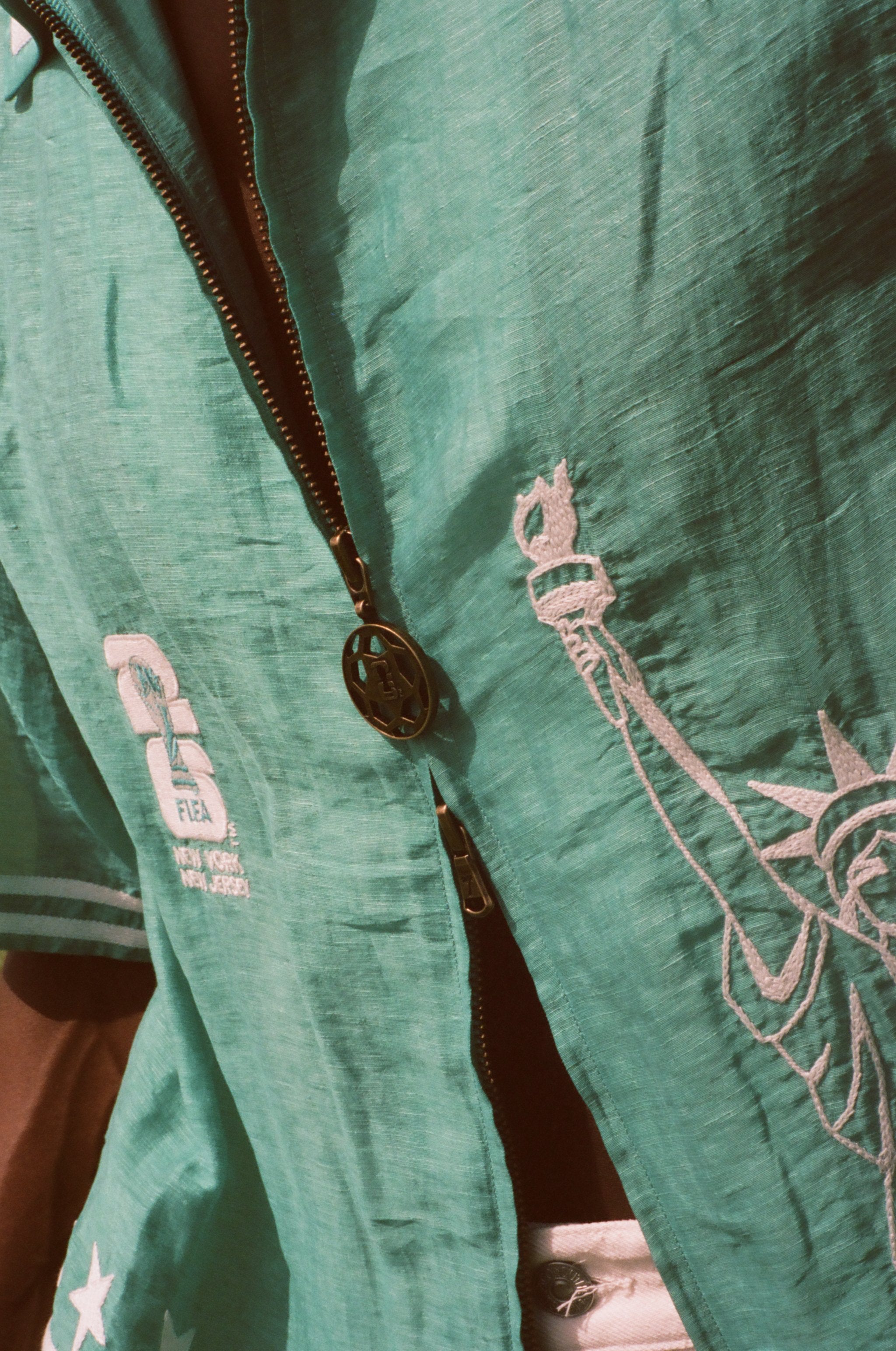 Close-up of the soccer zipper pull on the teal cabana. 