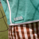 Close-up of Tombolo logo on the teal FIFA hand towel top.