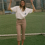 Woman wearing the 'Where were you?' Cabana, standing in front of a soccer net. 