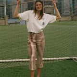 Woman wearing the 'Where were you?' Cabana, standing in front of a soccer net. 