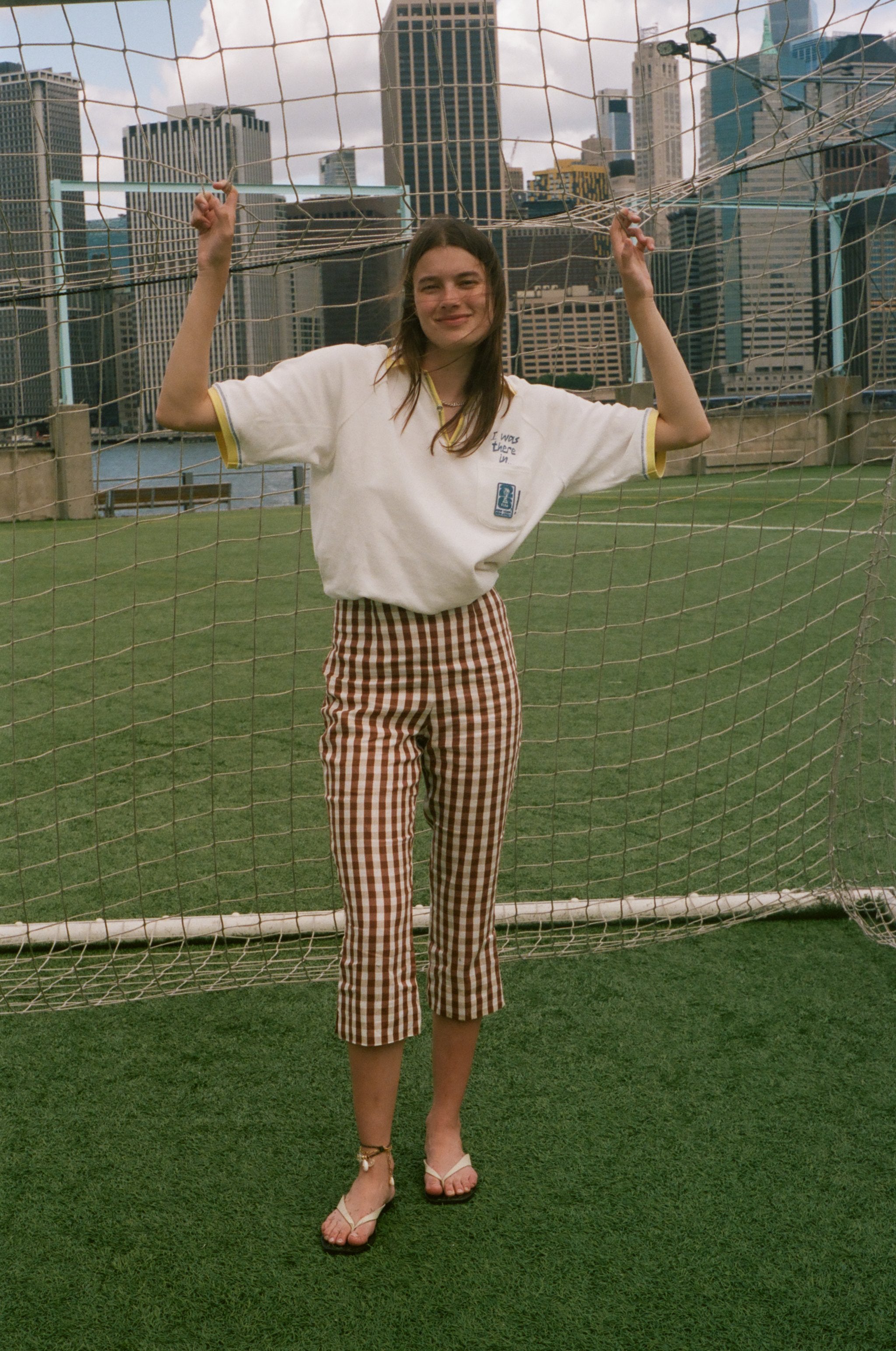 Woman wearing the 'Where were you?' Cabana, standing in front of a soccer net. 