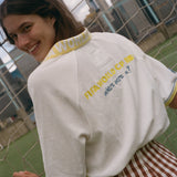 Woman showing off the back of her FIFA world cup cabana shirt. 