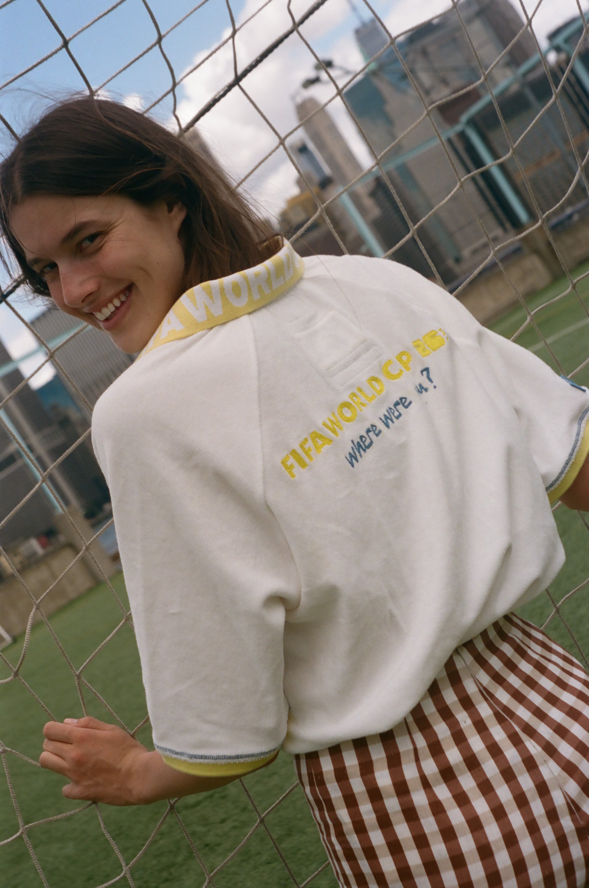 Woman showing off the back of her FIFA world cup cabana shirt. 