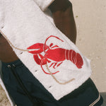 Close-up image of red embroidered lobster.