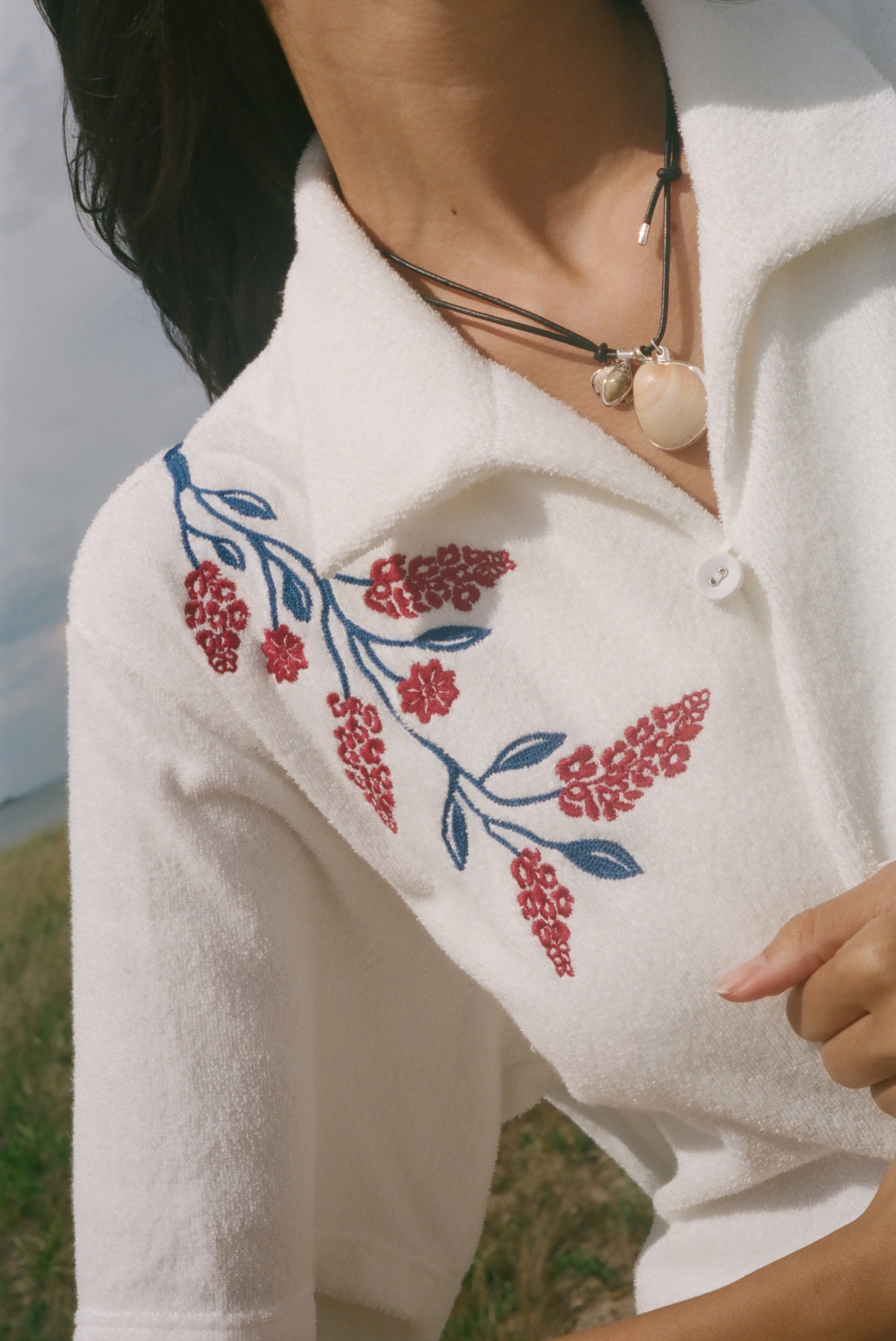 Close-up on the shoulder flower vine embroidery detail.