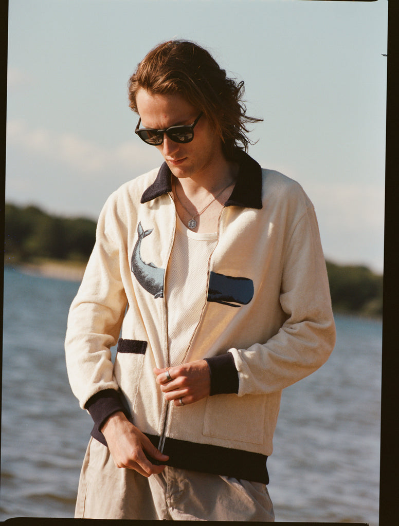 Image of man with long blonde hair, midway through zipping up the 'Blubber' Cabana.