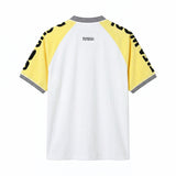 Back view of a white terry cloth shirt with yellow raglan sleeves, black printed lettering along the sleeves, a black-and-white striped ribbed collar and cuffs, and a small embroidered Tombolo logo centered below the neckline.